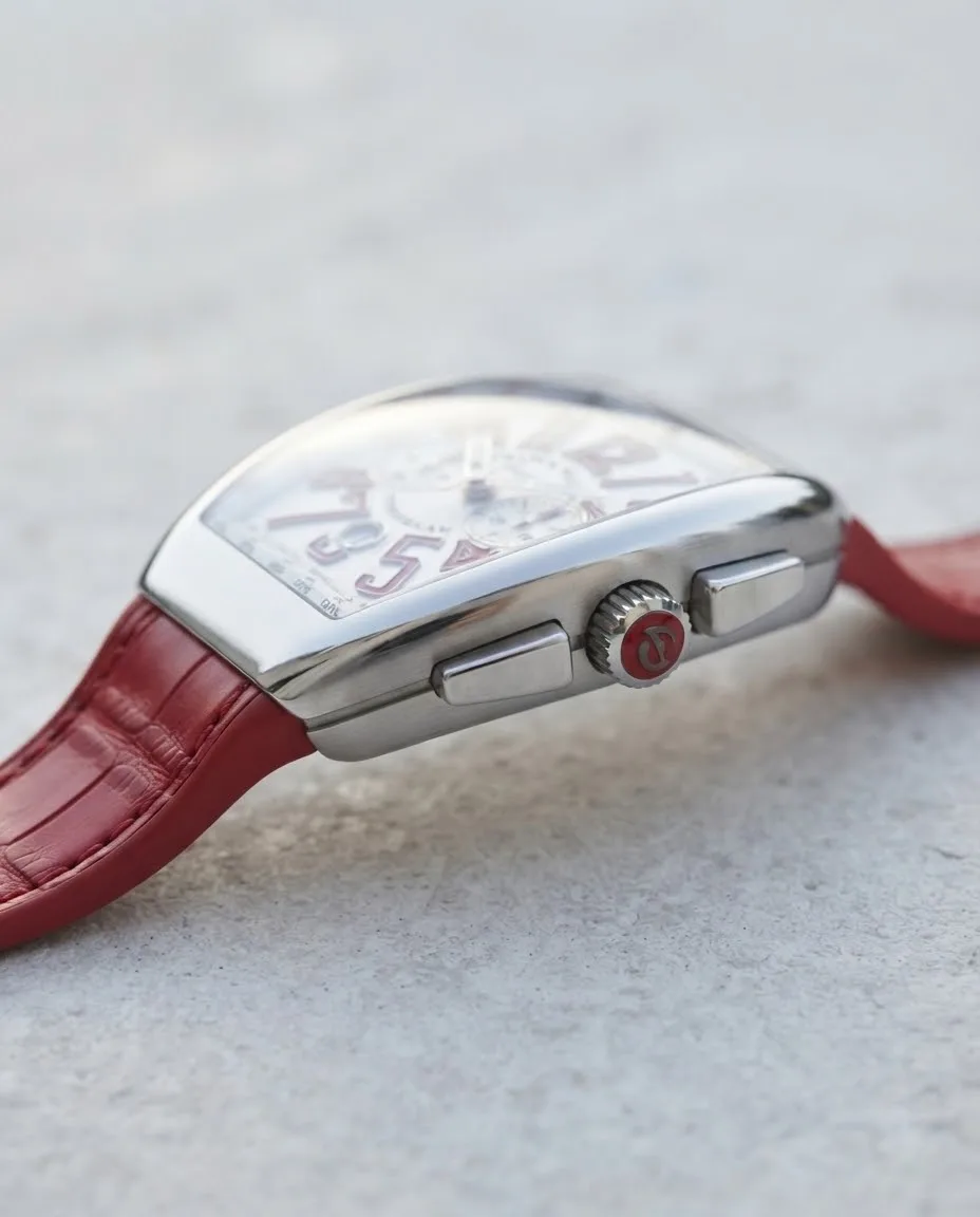 Illustrative render — reading the listing of the Franck Muller Vanguard V 45 CC DT chronograph (steel, white dial, red numerals, red alligator-grain leather-insert strap)
