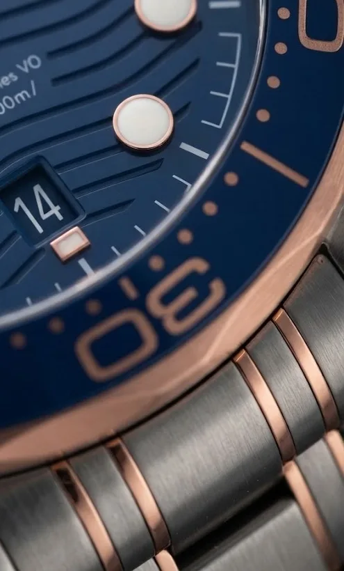 Illustrative render — the 2018 seamaster, and sedna of the Omega Seamaster Diver 300M Co-Axial Master Chronometer 42mm 210.20.42.20.03.002 (steel and Sedna gold, blue dial, bracelet)