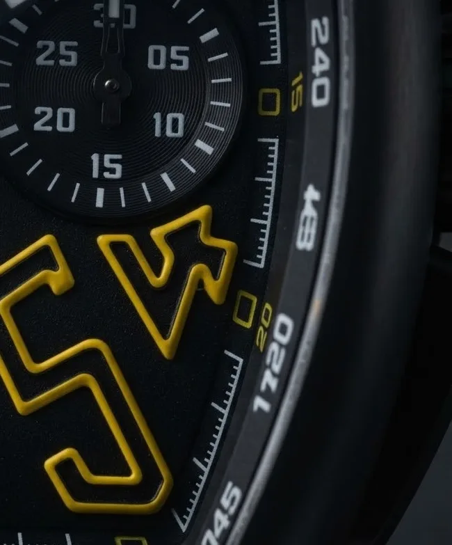 Illustrative render — one colour on a black watch of the Franck Muller Vanguard V 45 CC DT chronograph (black titanium, black dial, yellow-outlined numerals, black leather-insert strap with yellow stitching)