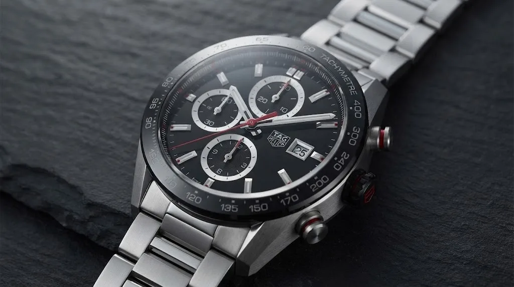 Illustrative render — hero view of the TAG Heuer Carrera Chronograph 41mm CBM2110.BA0651 (steel, black dial, ceramic bezel, steel bracelet, Calibre 16)