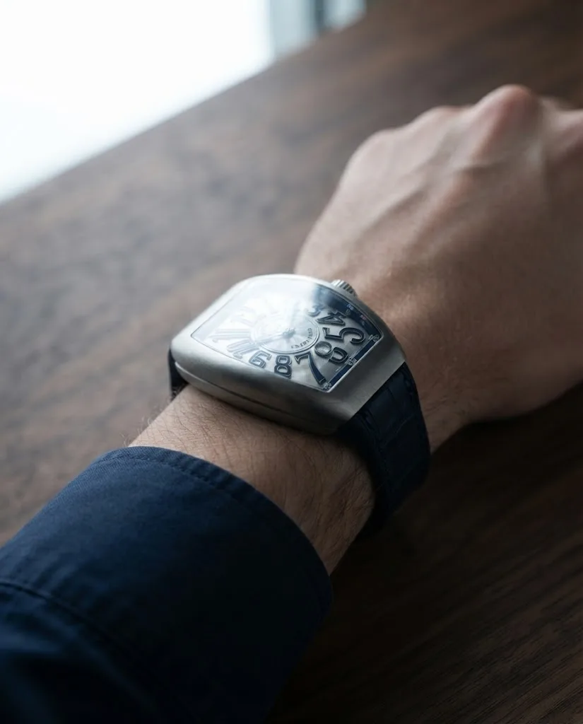 Illustrative render — buying it on amazon of the Franck Muller Vanguard Crazy Hours V 45 CH BR (BL) (brushed steel, blue numerals, black alligator strap with blue stitching)