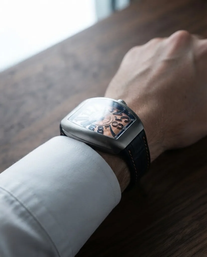 Illustrative render — buying it on amazon of the Franck Muller Vanguard Crazy Hours V 45 CH BR (orange) (brushed steel, orange numerals, black alligator strap with orange stitching)